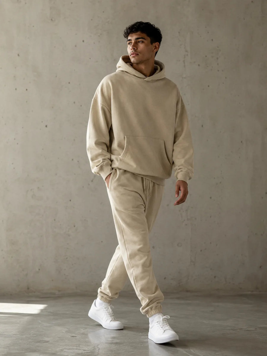 Modelo caminando con hoodie y jogger color arena